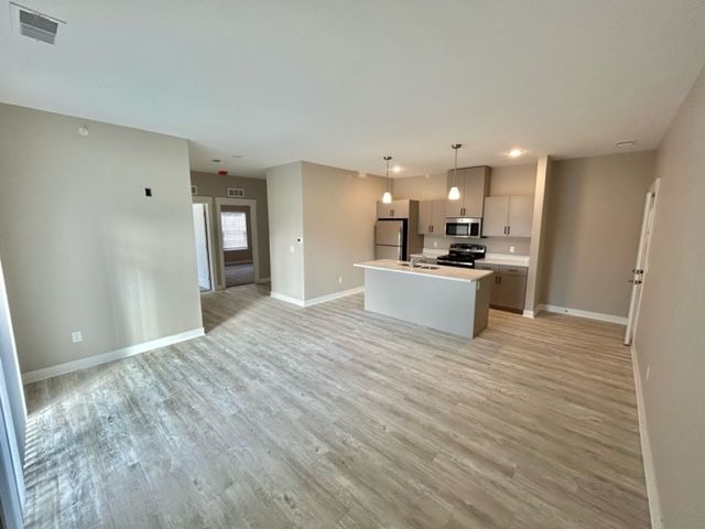 Unfurnished open kitchen and living area